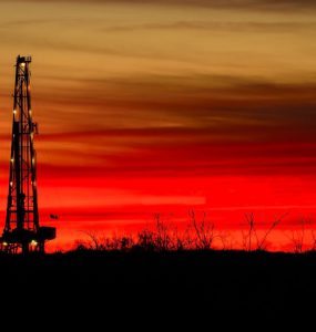 onshore oil and gas against a red sky